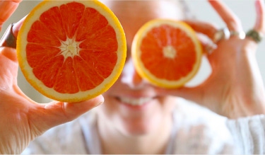 Person showing inside of sliced orange