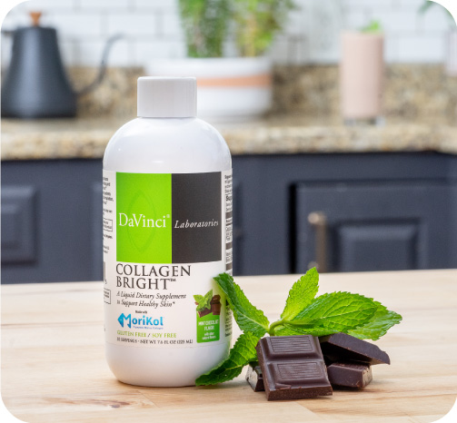 Collagen Bright Collagen Bright Mint Flavored bottle image with mint leaf and chocolate squares on a countertop.